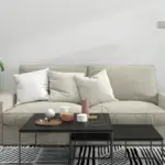 Modern living room showcasing the importance of rugs in interior design with a stylish black and white patterned rug complementing a neutral-toned sofa and contemporary decor.